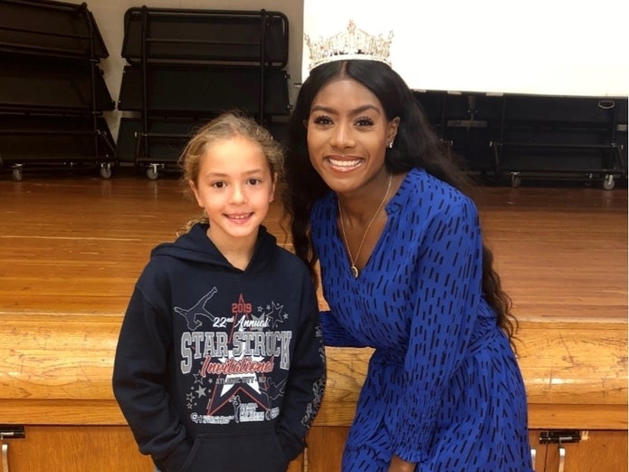 Miss America with student smiling for school event with Don't HIde it Flaunt it. 